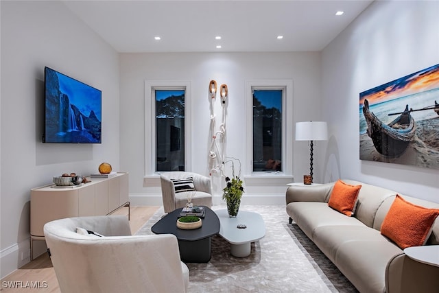 living area featuring recessed lighting, light wood-type flooring, and baseboards