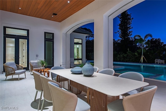 view of patio / terrace with an outdoor pool and outdoor dining area