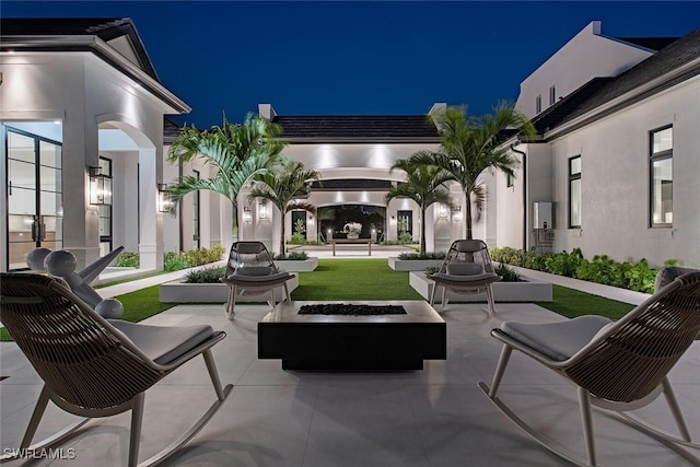 patio at night with a lawn