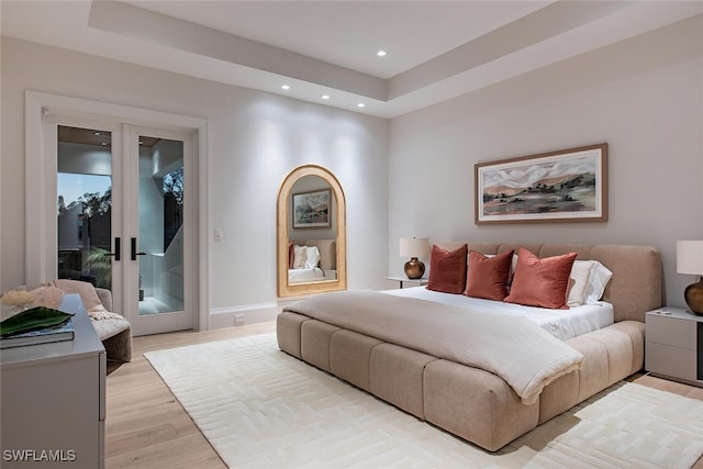 bedroom featuring recessed lighting, light wood-type flooring, baseboards, and access to outside