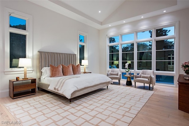 bedroom featuring recessed lighting, light wood-style floors, and high vaulted ceiling