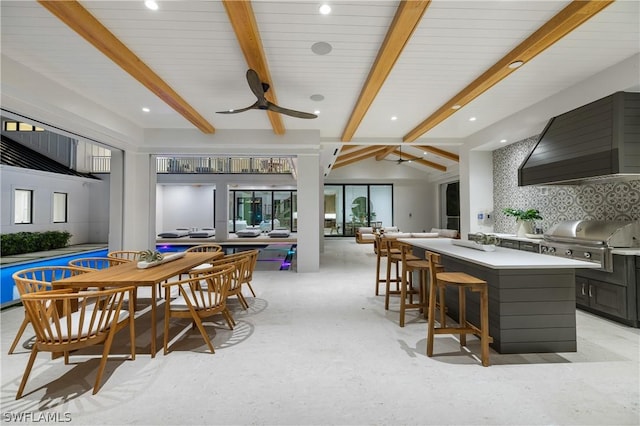 dining area with lofted ceiling with beams and ceiling fan