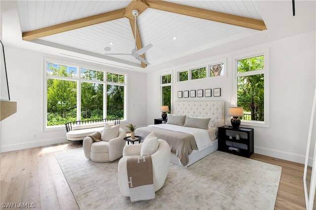 bedroom with beam ceiling and light hardwood / wood-style floors