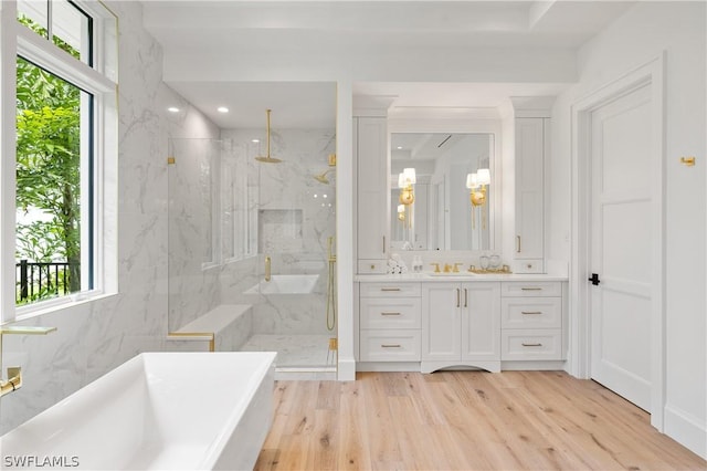 bathroom featuring hardwood / wood-style floors, separate shower and tub, and plenty of natural light