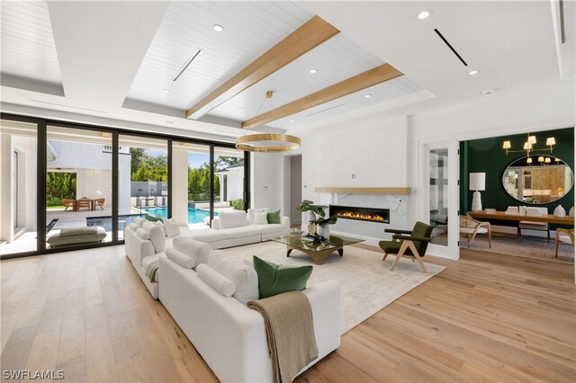 living room with beam ceiling, floor to ceiling windows, wooden ceiling, light hardwood / wood-style flooring, and a high end fireplace