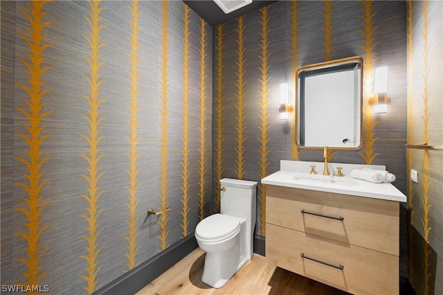 bathroom featuring hardwood / wood-style flooring, vanity, and toilet