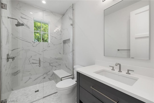 bathroom featuring vanity, toilet, and an enclosed shower