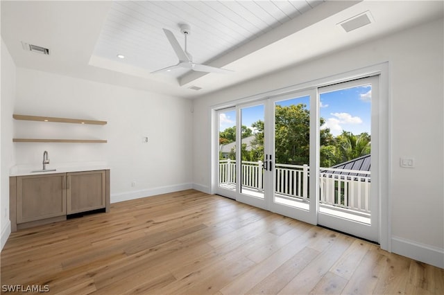 interior space featuring ceiling fan, sink, light hardwood / wood-style flooring, and french doors