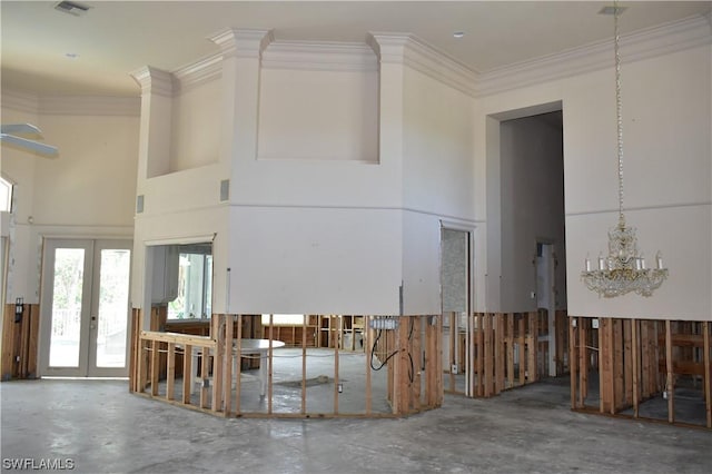 misc room with an inviting chandelier, a towering ceiling, crown molding, and french doors