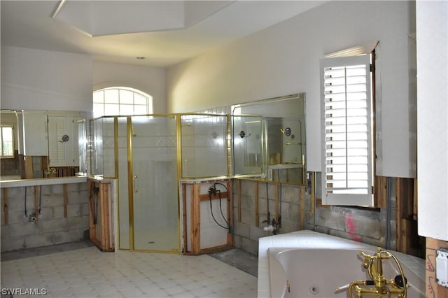 bathroom featuring independent shower and bath