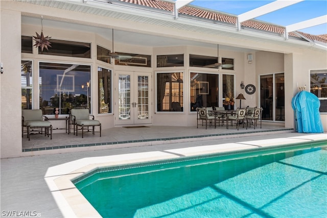 view of pool featuring a patio, ceiling fan, and french doors