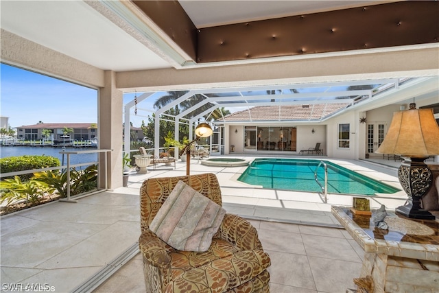 view of swimming pool featuring a patio area, a lanai, and a water view