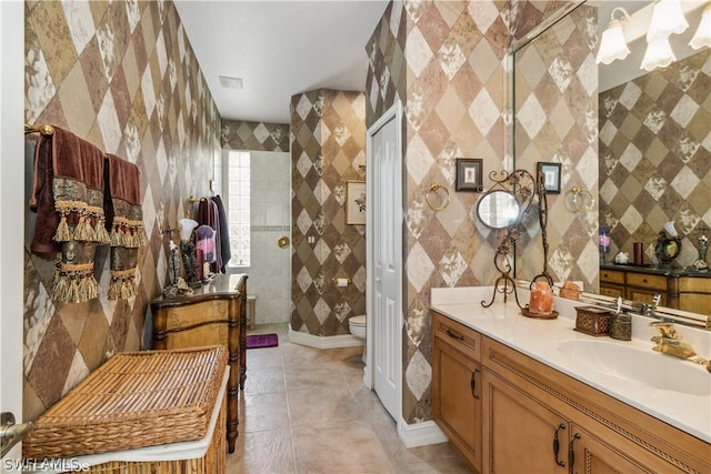 bathroom featuring tile floors, oversized vanity, toilet, and tile walls