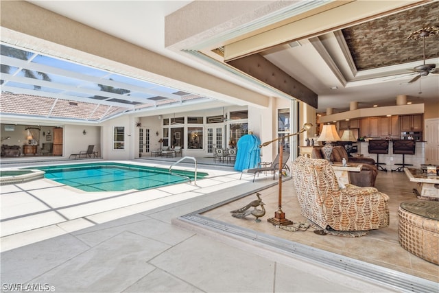 view of pool featuring french doors, ceiling fan, and a patio area