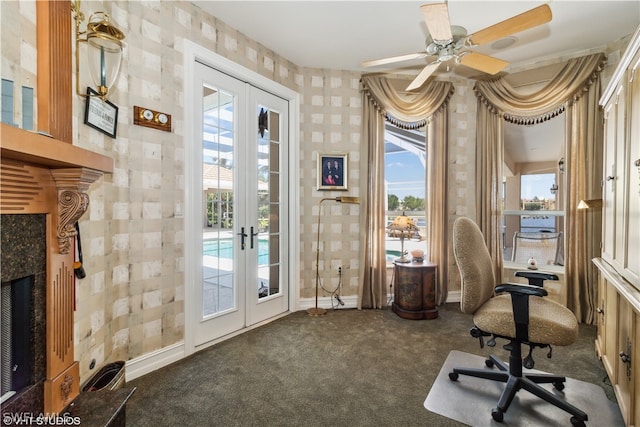 office with dark colored carpet, a high end fireplace, ceiling fan, and french doors