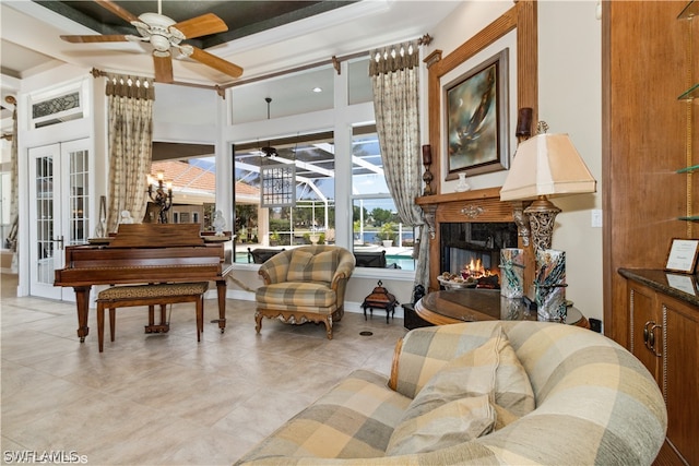 tiled living room with french doors and ceiling fan