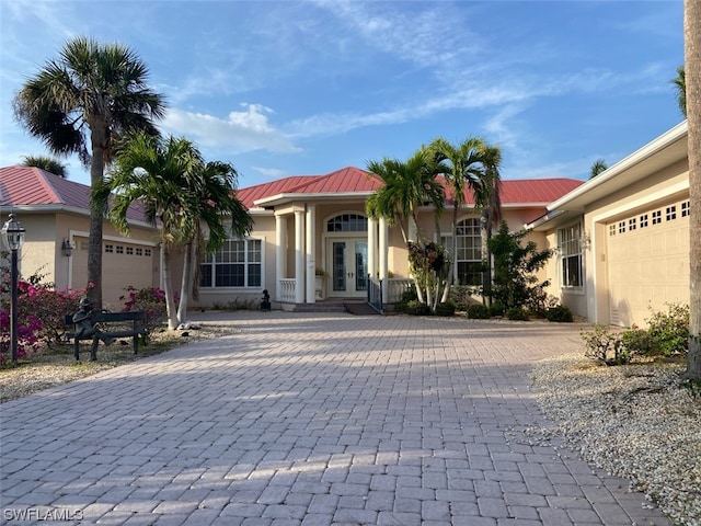 view of front of house with a garage and french doors