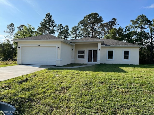 view of front of house with a front yard and a garage