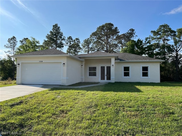 view of front of home with a front yard and a garage