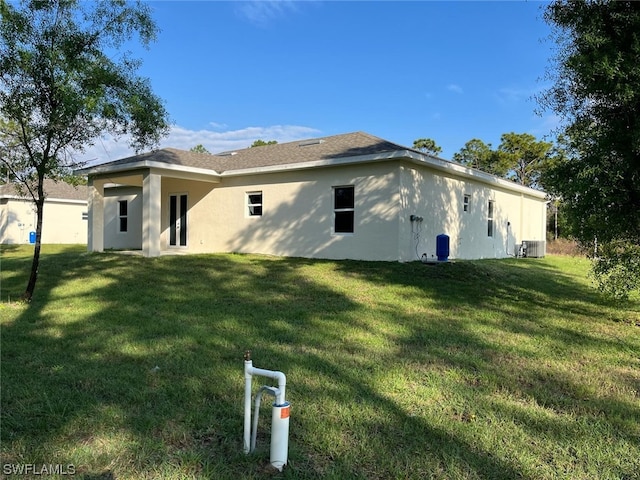 view of property exterior featuring central AC unit and a yard