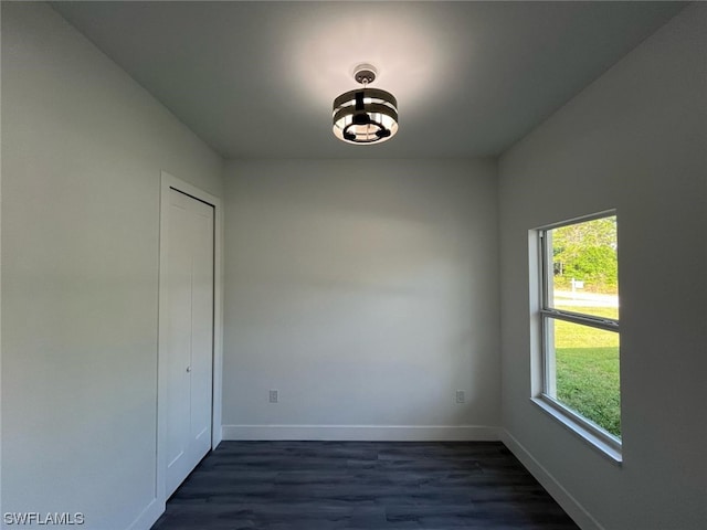 spare room with dark wood-type flooring