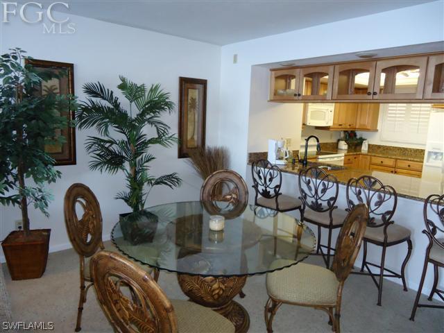 carpeted dining area with sink