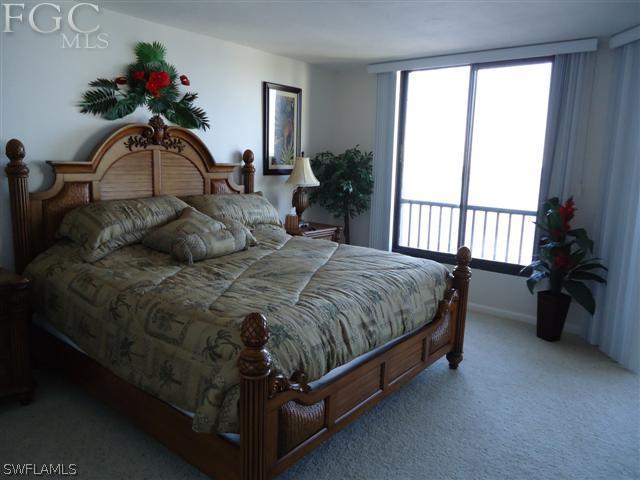 carpeted bedroom with access to outside and multiple windows