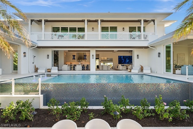 back of property with a patio and a balcony