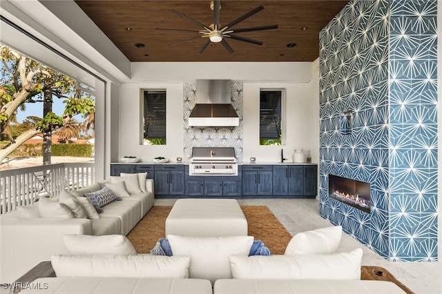 living room featuring ceiling fan, wooden ceiling, and sink