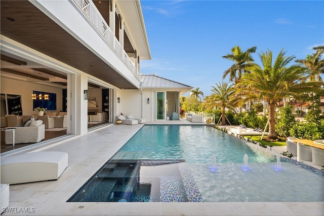 view of pool with an in ground hot tub, pool water feature, and a patio