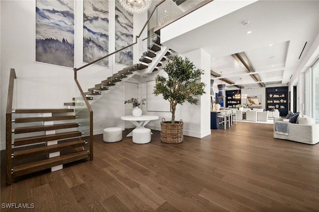 stairway featuring hardwood / wood-style flooring and beamed ceiling