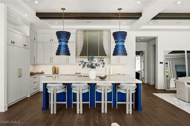 kitchen with pendant lighting, wall chimney exhaust hood, dark hardwood / wood-style floors, and white cabinets