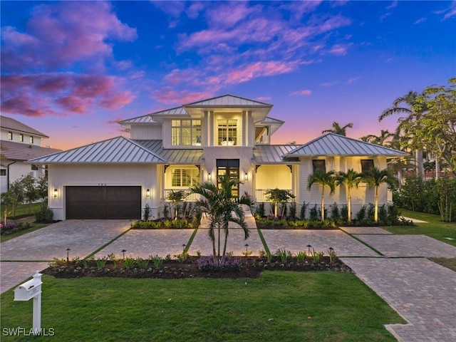 view of front facade with a yard and a garage