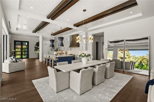 dining space featuring a notable chandelier, beam ceiling, wood-type flooring, and a wealth of natural light