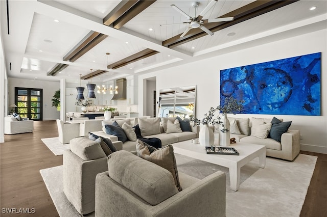 living room with hardwood / wood-style floors, ceiling fan, and beamed ceiling