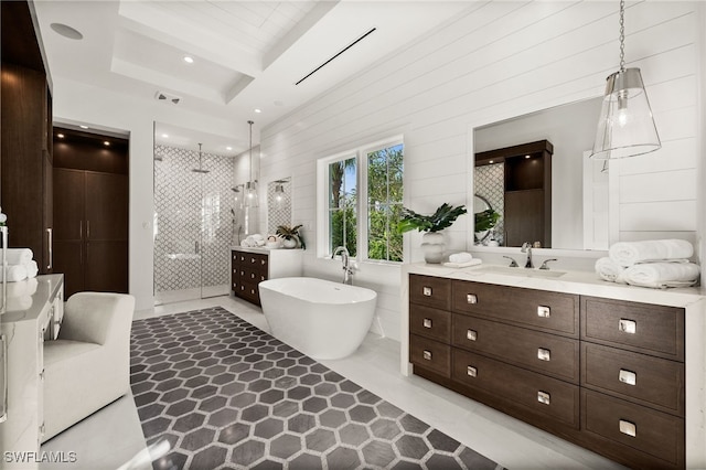 bathroom featuring tile patterned flooring, vanity, a raised ceiling, and plus walk in shower