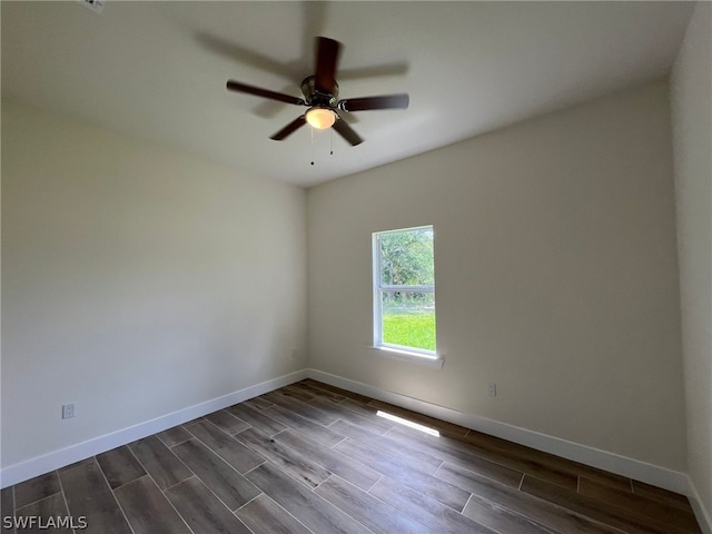 unfurnished room featuring ceiling fan and dark hardwood / wood-style flooring