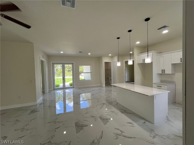 kitchen with white cabinets, ceiling fan, and light tile flooring