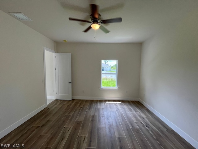 spare room featuring ceiling fan and dark hardwood / wood-style flooring