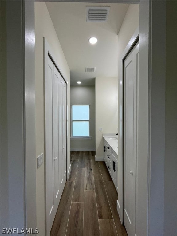 hall with dark hardwood / wood-style flooring