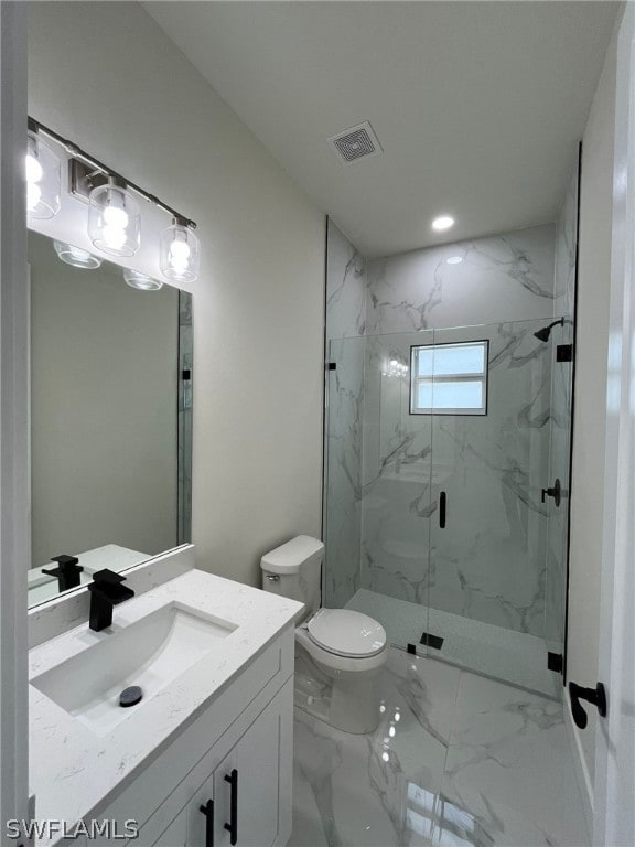 bathroom featuring a shower with shower door, tile flooring, vanity, and toilet