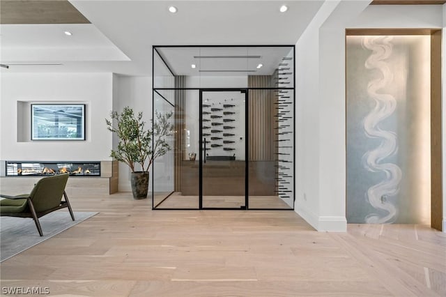 wine area with light hardwood / wood-style flooring