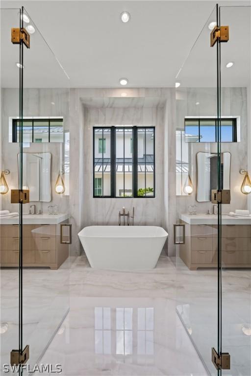 bathroom featuring shower with separate bathtub and vanity