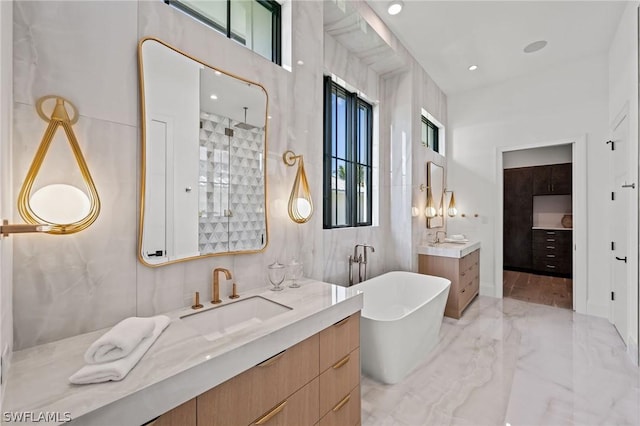 bathroom featuring a washtub and vanity