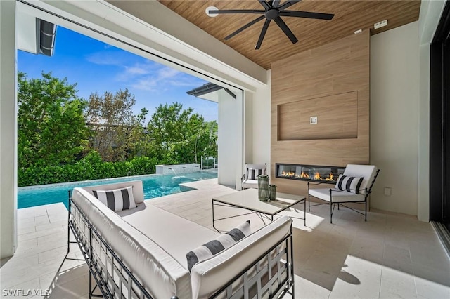 view of patio featuring outdoor lounge area, ceiling fan, and pool water feature