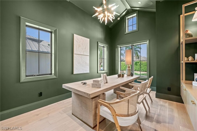 office featuring a notable chandelier, light hardwood / wood-style floors, and lofted ceiling