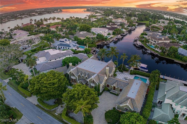 aerial view at dusk with a water view