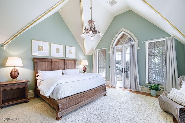 bedroom featuring a notable chandelier, access to outside, and vaulted ceiling