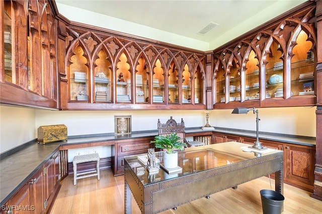 office area with light hardwood / wood-style flooring and built in desk