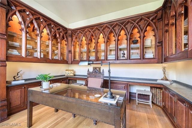 office featuring built in desk and light hardwood / wood-style floors